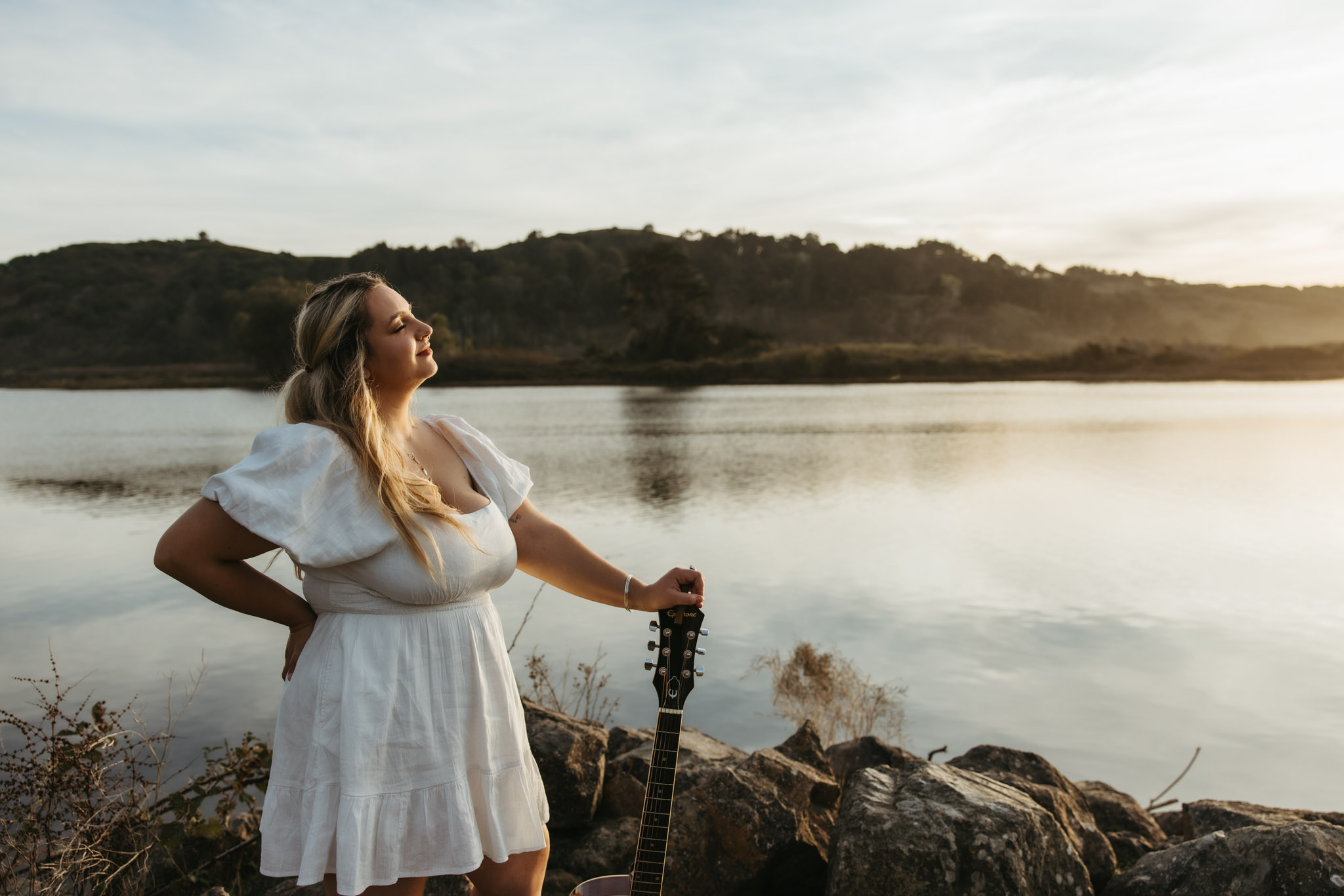 Sunny Mitchell with guitar at sunset